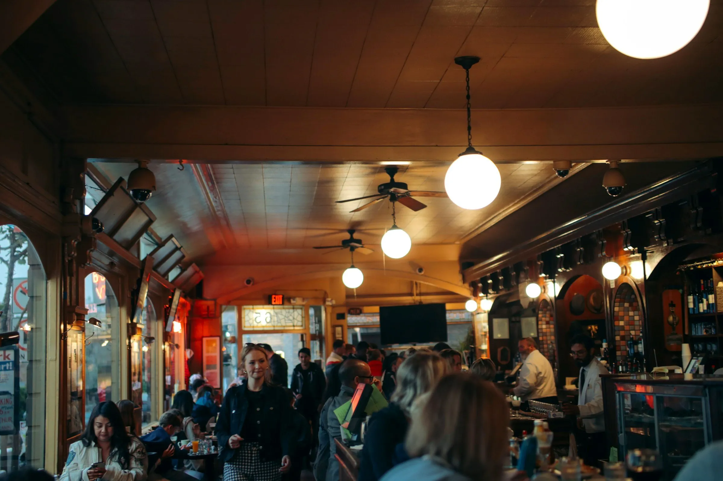 A full restaurant at night, warm light and every table taken
