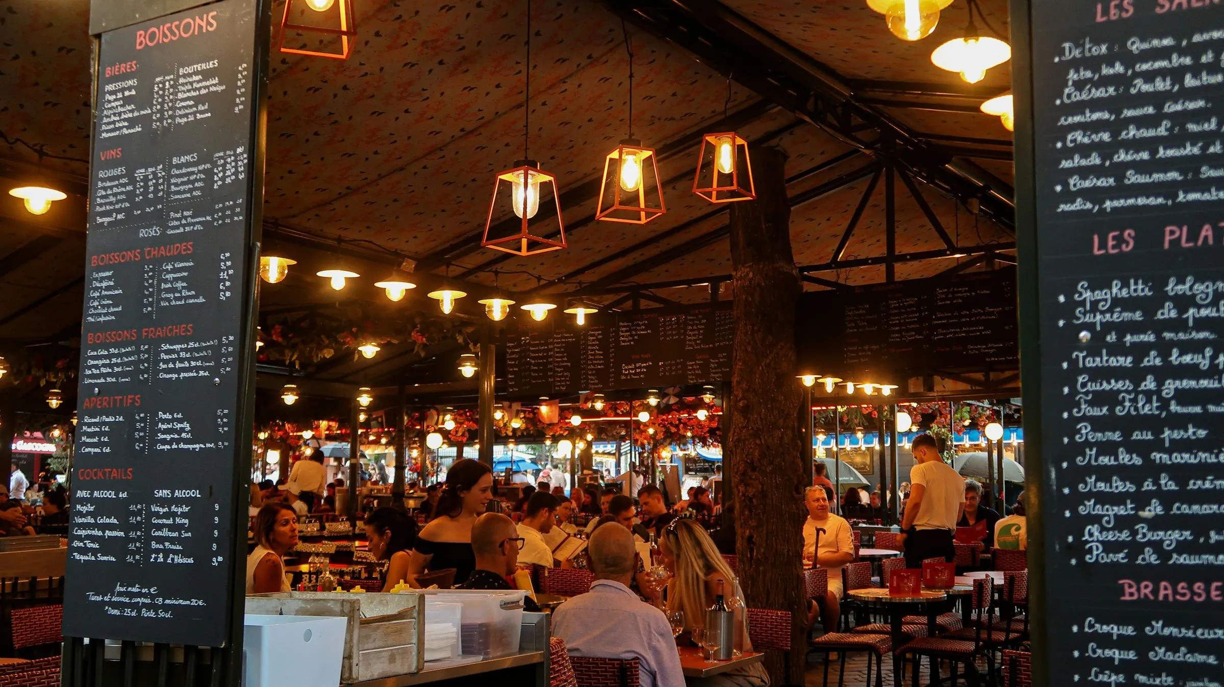 A packed bistro dining room in the evening