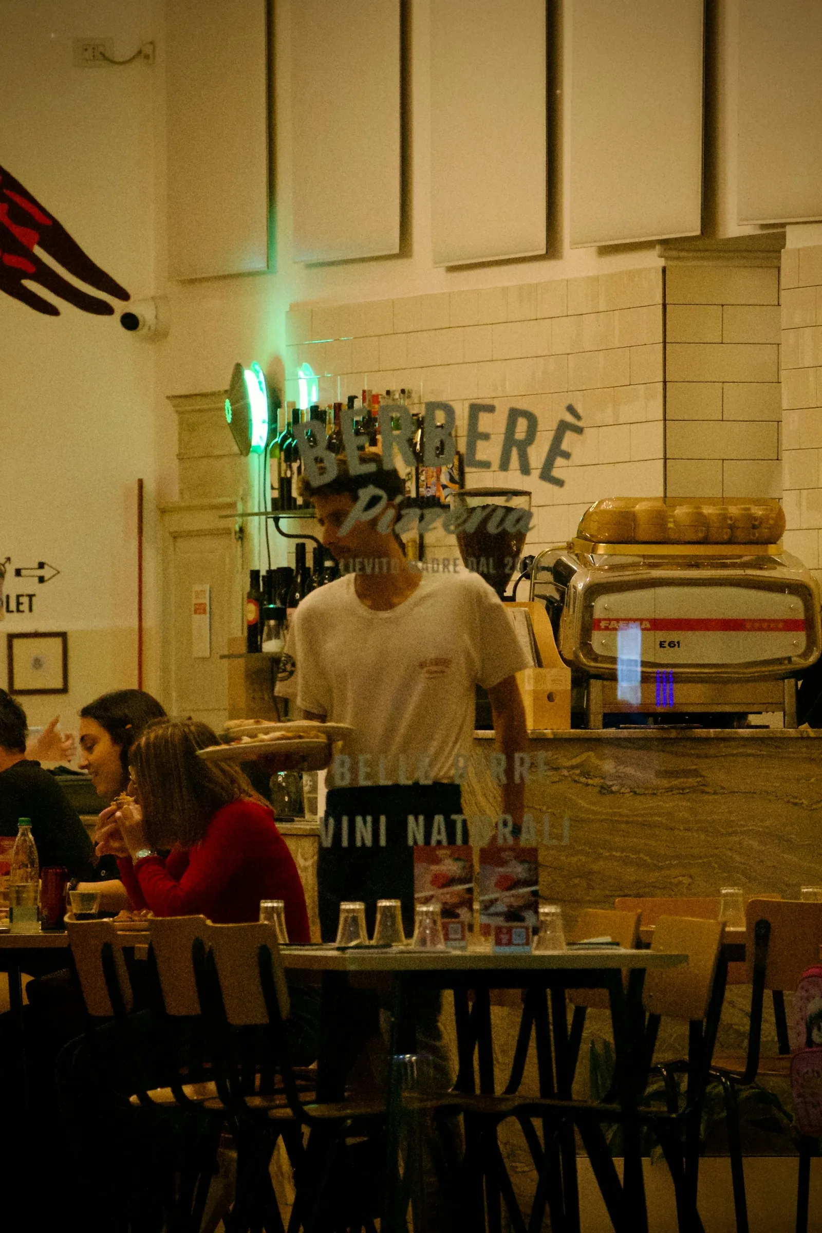 A busy restaurant with a full dining room and staff at work